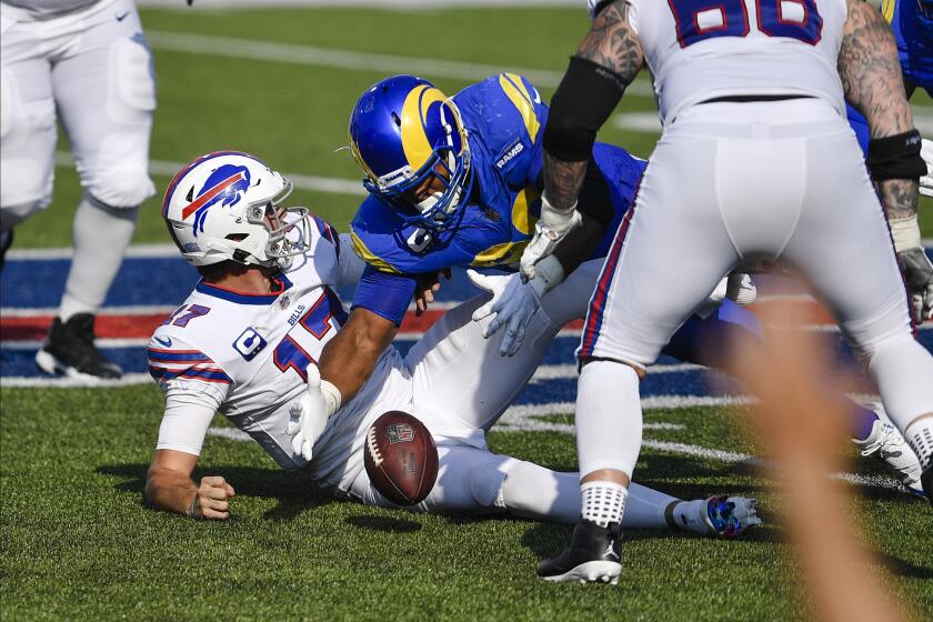 Los Angeles Rams' Aaron Donald (99) recovers the ball fumbled by Buffalo Bills quarterback Josh Allen during the second half of an NFL football game Sunday, Aug. 26, 2018, in Orchard Park, N.Y. (AP Photo/Adrian Kraus)