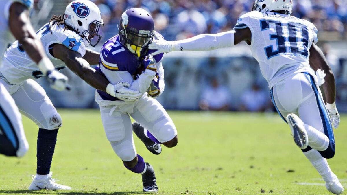 Vikings running back Jerick McKinnon carries the ball against the Titans during an exhibition game on Sept. 11.