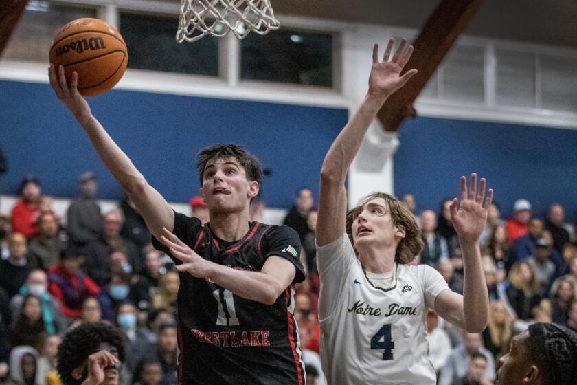 Brady Dunlap of Harvard-Westlake goes against Dusty Stromer of Sherman Oaks Notre Dame.