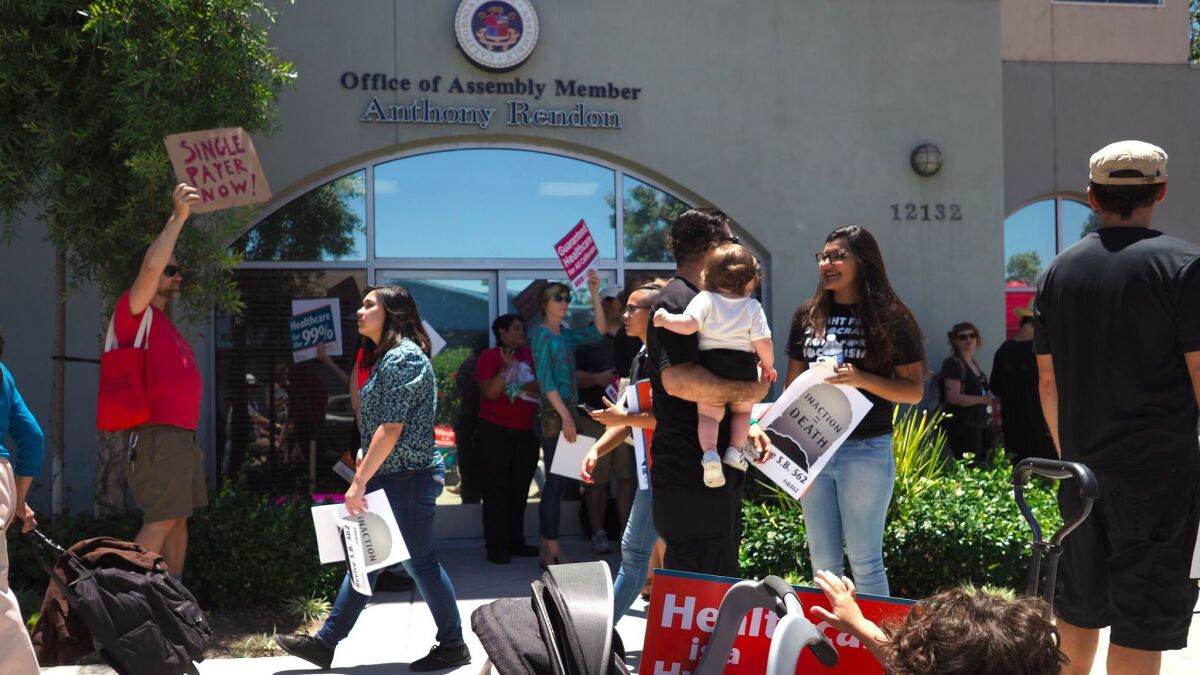 People rally in favor of single-payer healthcare in California outside Assembly Speaker Anthony Rendon's office in South Gate on June 27.