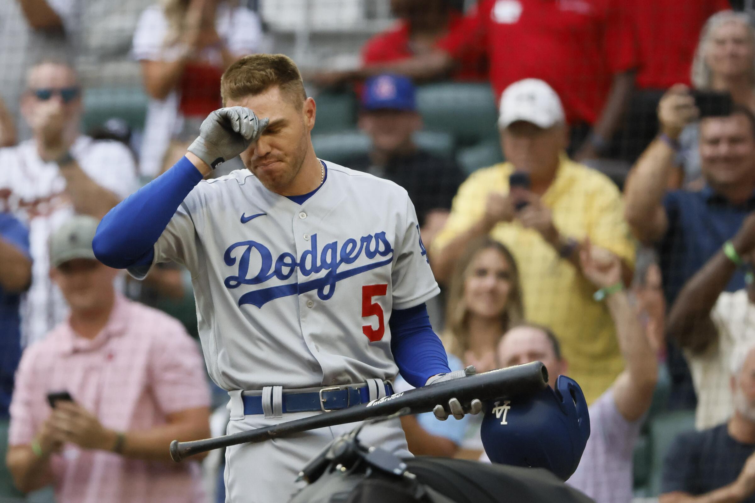 Dodgers star Freddie Freeman reacts to a standing ovation during his first at-bat against the Atlanta Braves.