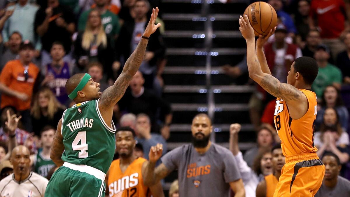 Suns point guard Tyler Ulis pulls up for the game-winning three-point shot over Celtics point guard Isaiah Thomas in the final moments of their game Sunday.