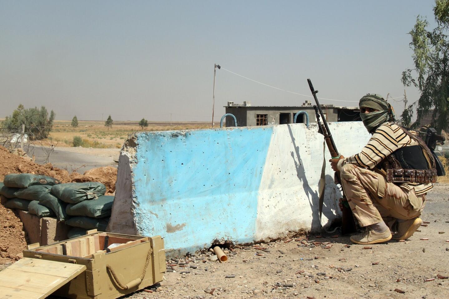 A Shiite Turkmen fighter holds a position on Aug. 4 in Amerli, Iraq.
