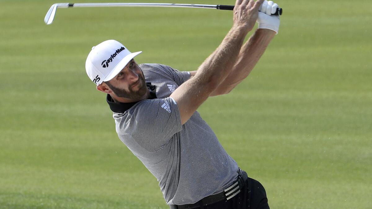 Dustin Johnson hits an approach shot during the second round of the HSBC Champions tournament on Friday.