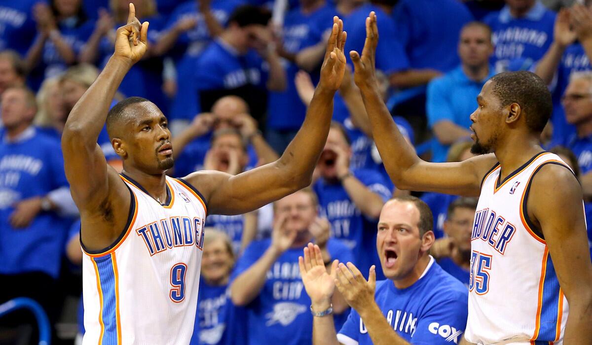 Thunder power forward Serge Ibaka (9) celebrates with teammate Kevin Durant (35) late in the fourth quarter of a victory over the San Antonio Spurs on Sunday night in Oklahoma City.