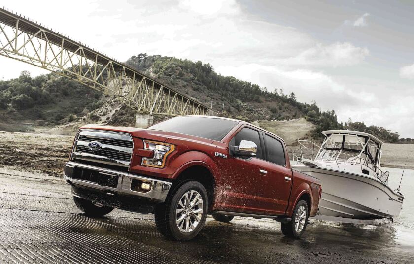 A Ford F-150 pickup tows a boat out of water.
