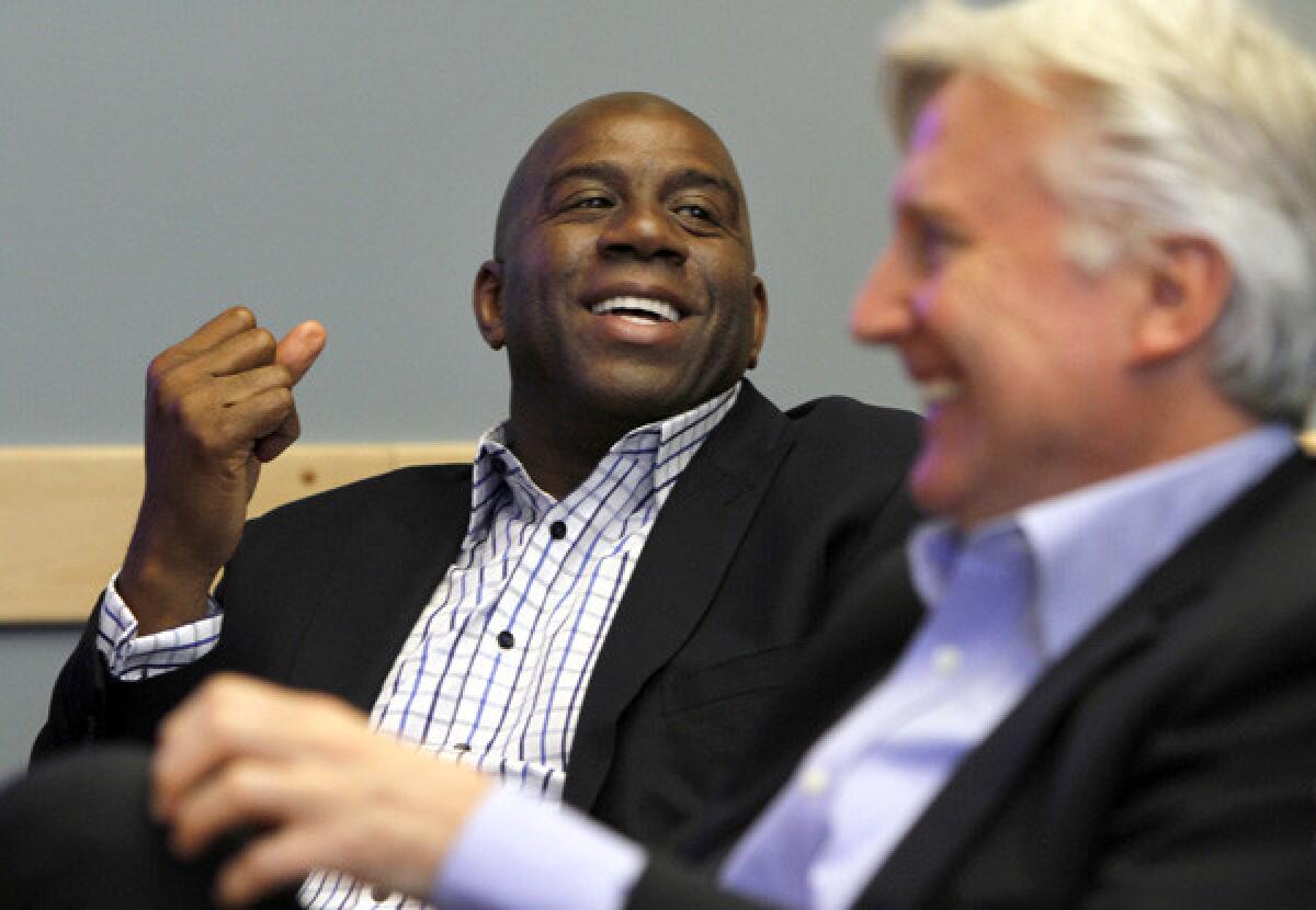 Magic Johnson, with fellow Dodgers owner Mark Walter, is among the people that think Lakers owner and executive Jim Buss could use help running the team.
