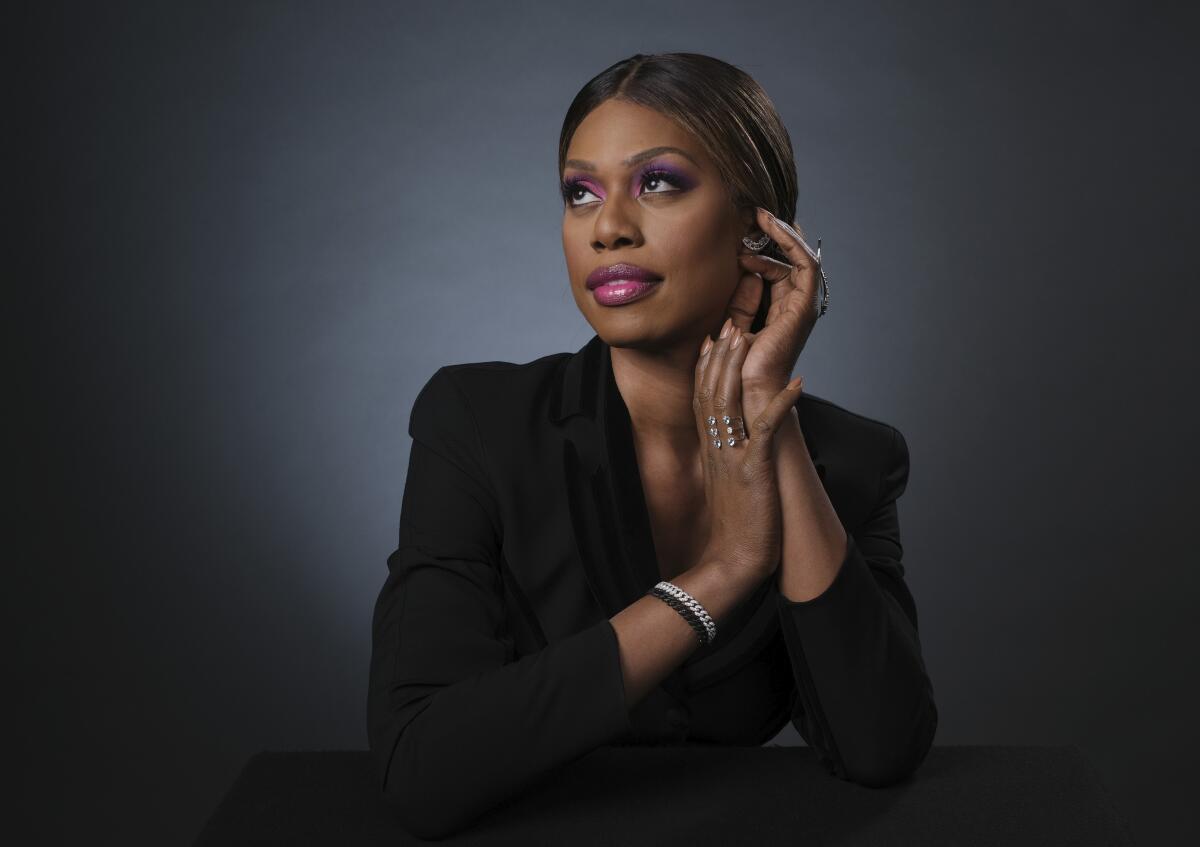 Laverne Cox posing in a black blazer