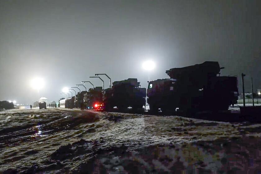 In this photo taken from video provided by the Russian Defense Ministry Press Service on Saturday, Jan. 29, 2022, Russian military vehicles prepares to drive off a railway platforms after arrival in Belarus. In a move that further beefs up forces near Ukraine, Russia has sent an unspecified number of troops from the country's far east to its ally Belarus, which shares a border with Ukraine, for major war games next month. (Russian Defense Ministry Press Service via AP)