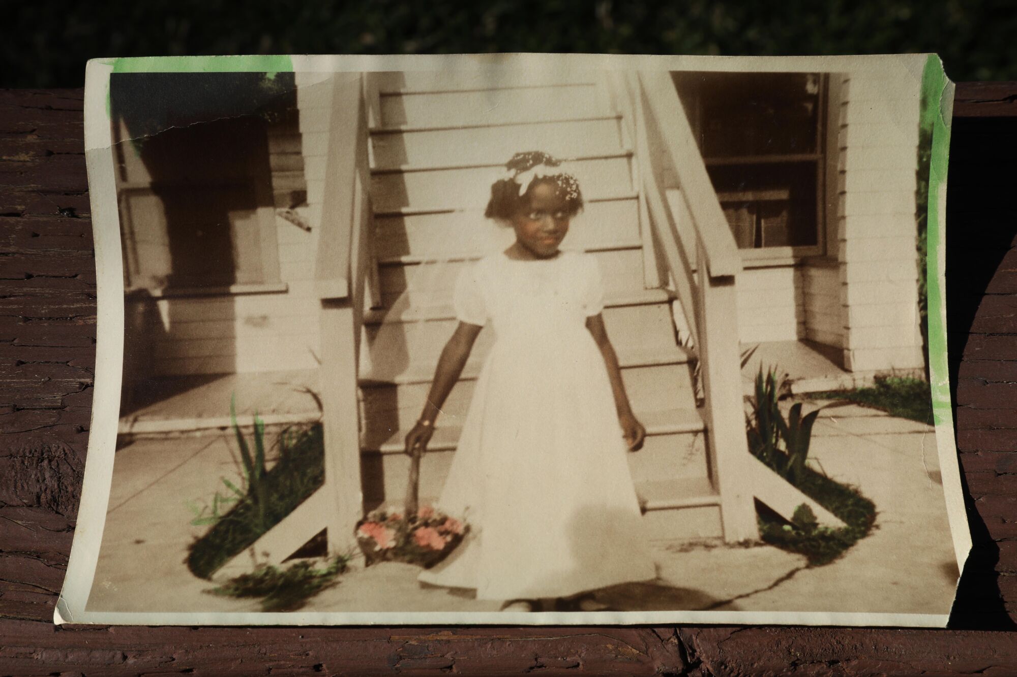 A photograph of Cristyne Lawson as a young flower girl at a wedding in the late 1930s.