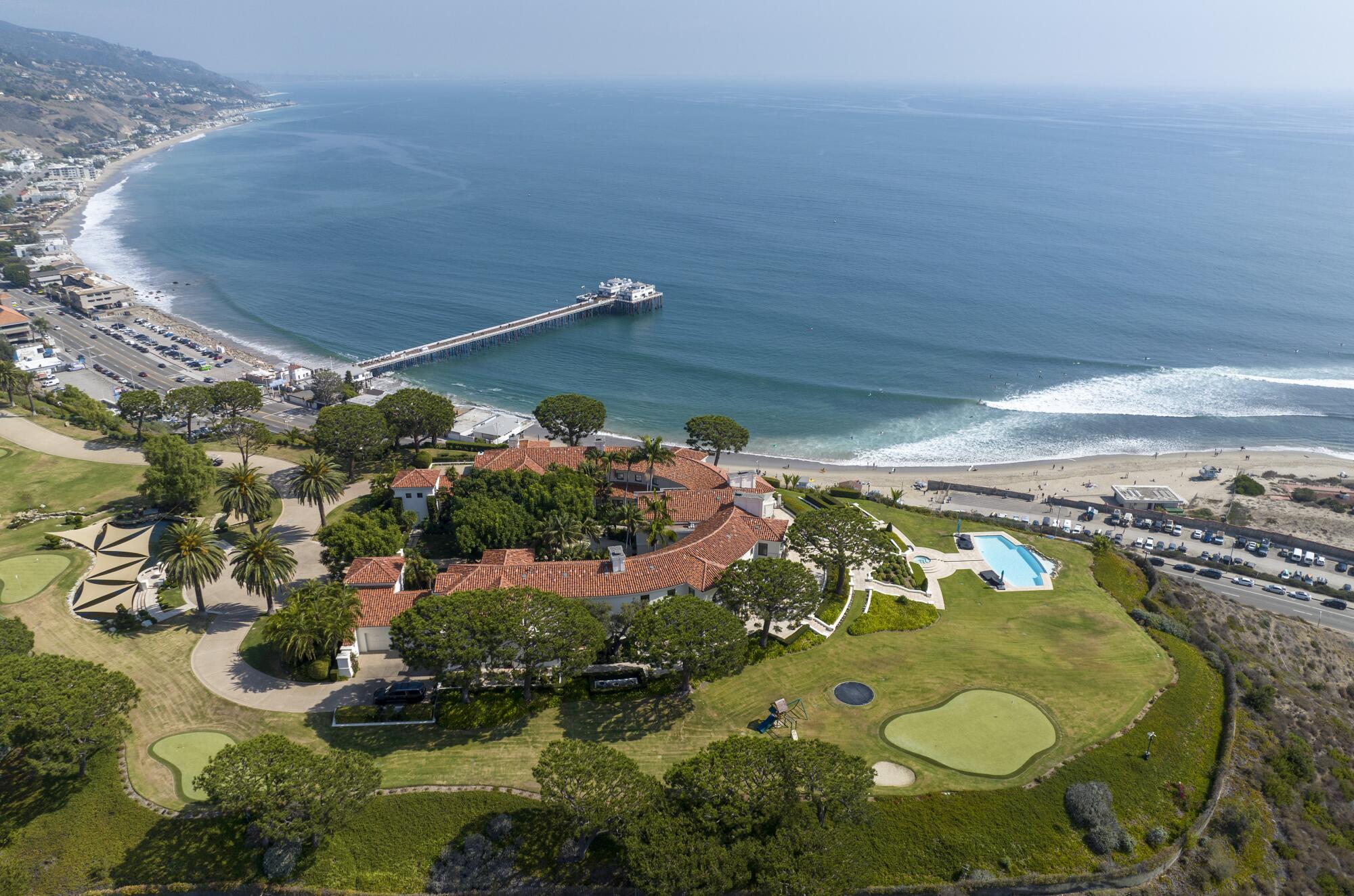 The Malibu mansion sits on a bluff overlooking Malibu Pier and the Pacific Ocean.