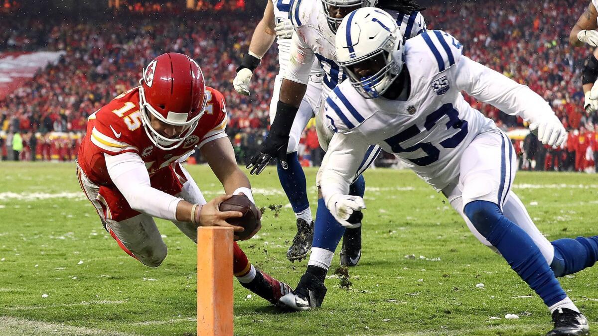 Chiefs quarterback Patrick Mahomes dives for the goal line to score a touchdown against the Colts on a four-yard run Saturday.