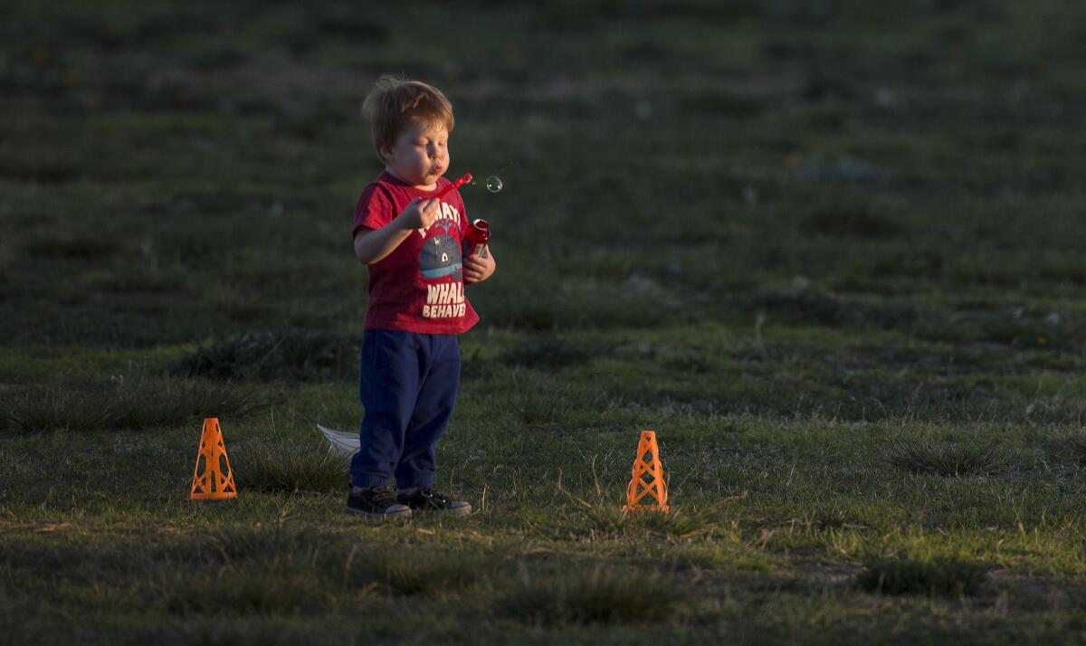 Will the air be improving soon? Caeden Quarles, 2, blows bubbles at Holleigh Bernson Memorial Park in Porter Ranch, Calif.