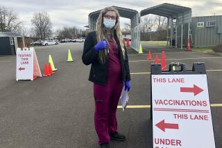 Roane General Hospital nurse Chania Batten is shown at a drive-thru COVID-19 vaccination clinic Tuesday, Dec. 21, 2021, in Spencer, W.Va. Batten says her job at times is overwhelming administering COVID-19 vaccines at the clinic at the only hospital in rural Roane County. She's spent months patiently answering questions, dispelling misinformation and reassuring the skeptical that the shots are the key to beating back the virus. (AP Photo/John Raby)