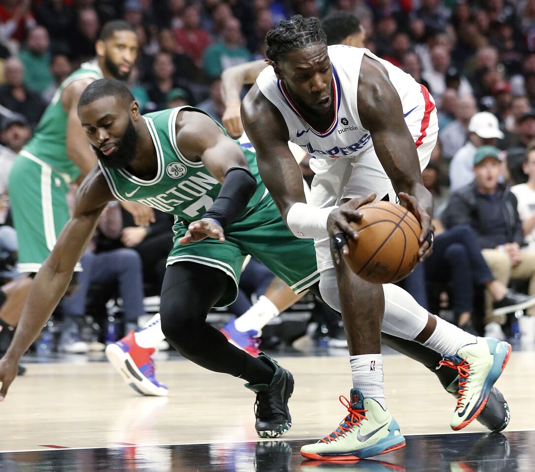 Clippers forward Montrezl Harrell steals the ball from Celtics guard Jaylen Brown during the fourth quarter of a game Nov. 20 at Staples Center.