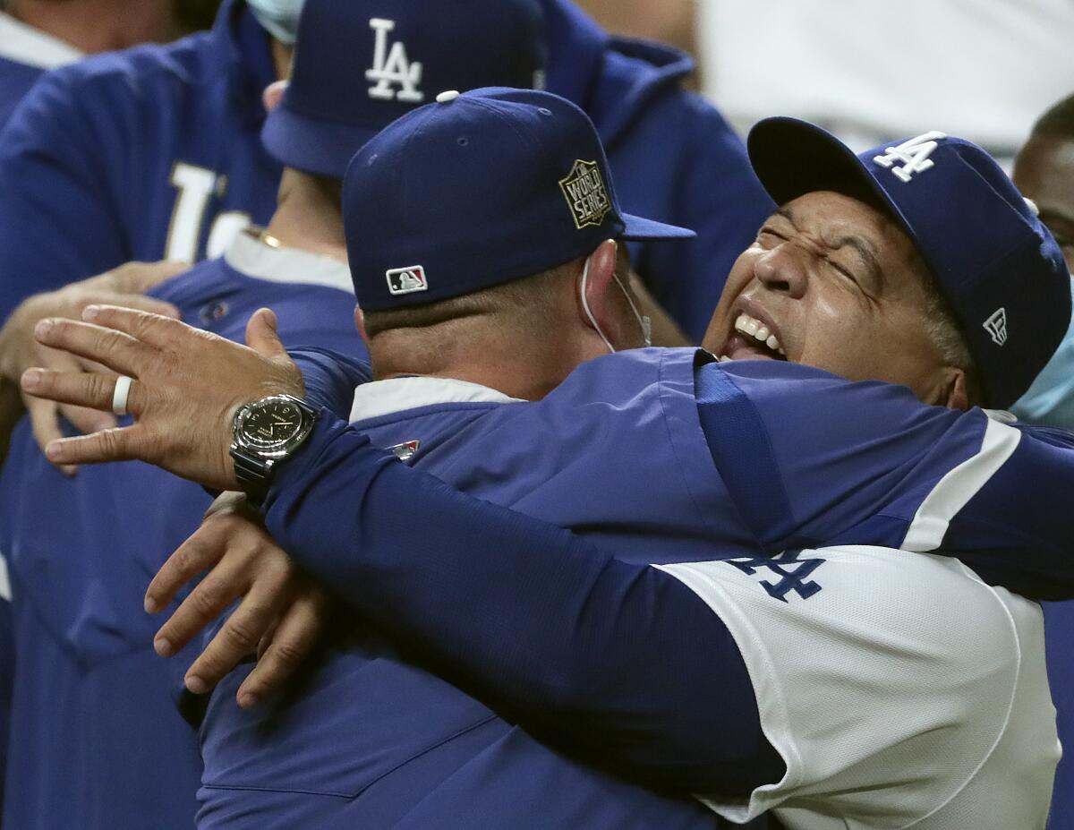 Dave Roberts shares a hug after the World Series win.