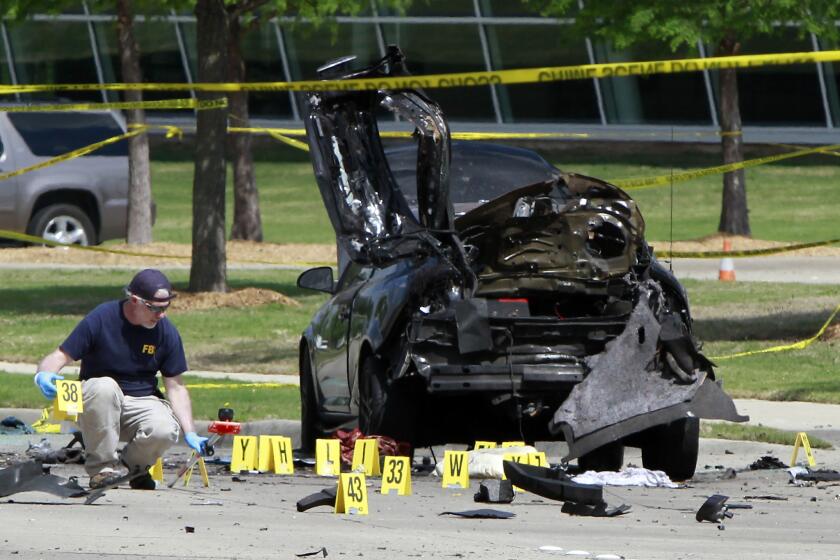 Members of the FBI Evidence Response Team investigate the crime scene outside of the Curtis Culwell Center on May 4, 2015, after a shooting in Garland, Texas.