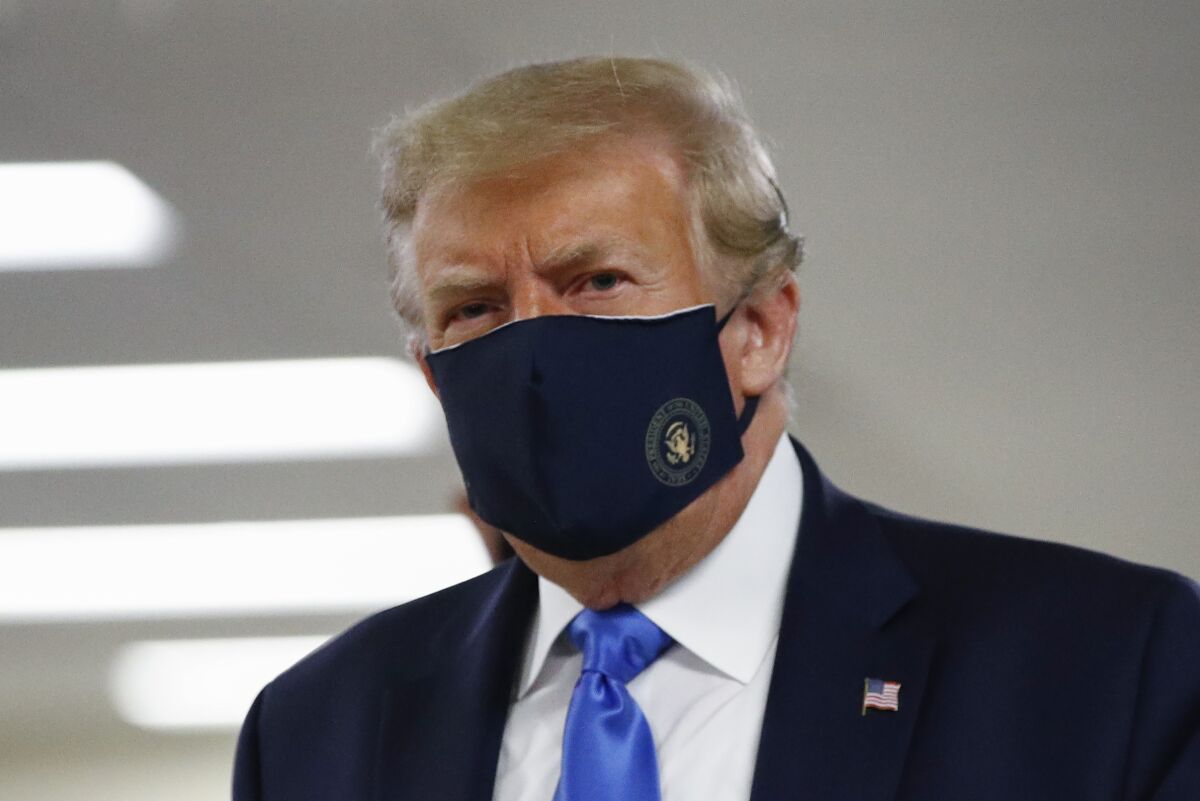 President Trump wears a face mask on July 11 during a visit to Walter Reed National Military Medical Center in Bethesda, Md.