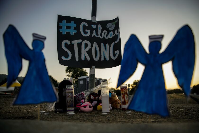 GILROY, CALIF. - JULY 30: A memorial, to those that lost their lives in the mass shooting at the Gilroy Garlic Festival, sits on the roadside, at the intersection of Uvas Parkway and Miller Avenue on Tuesday, July 30, 2019 in Gilroy, Calif. (Kent Nishimura / Los Angeles Times)