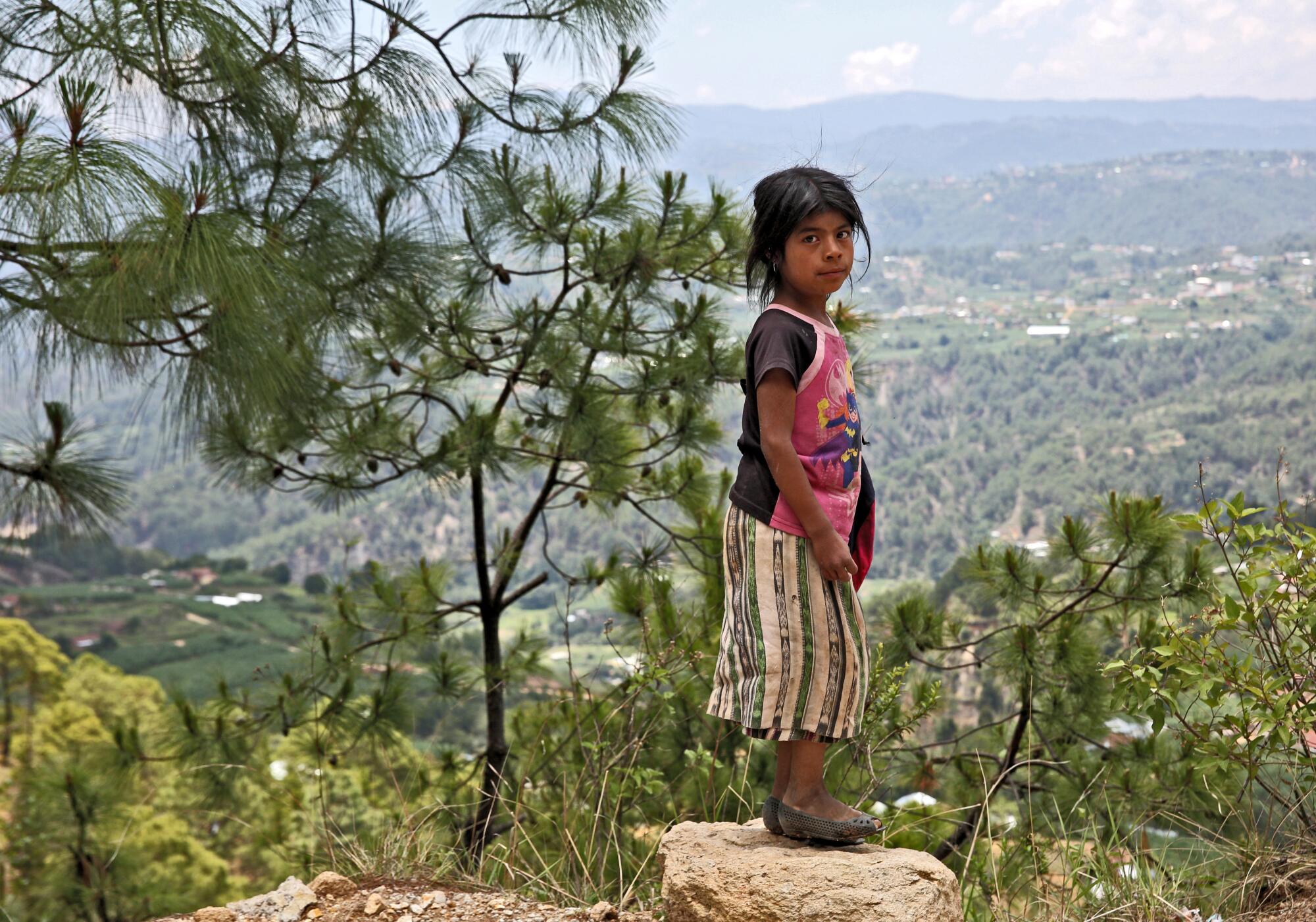 A young girls walks along alongside the road leading to Caserio Loma Linda, Aldea Chixal, Comitancillo, San Marcos