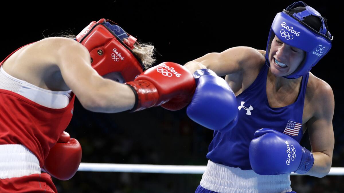 American boxer Mikaela Mayer connects with an overhand right against Russia's Anastasiia Beliakova during their quarterfinal bout on Monday.
