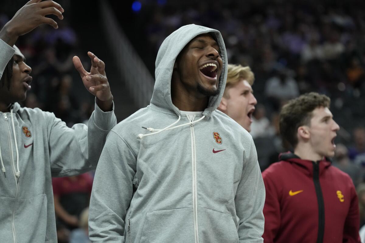 USC guard Bronny James cheers from the bench during the Trojans' season opener against Kansas State in Las Vegas.