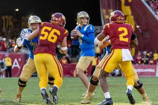 UCLA quarterback Ethan Garbers looks for an open receiver against USC at the Coliseum on Nov. 18, 2023.