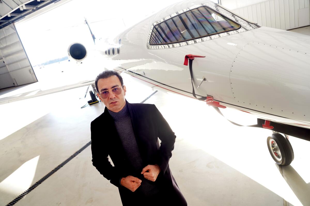 Richard Zaher stands next to a private jet.