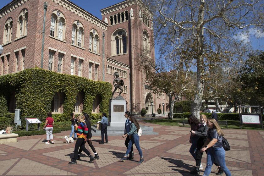 LOS ANGELES, CALIF. -- TUESDAY, MARCH 12, 2019: A view of people visiting the University of Southern California in Los Angeles, Calif., on March 12, 2019. Federal prosecutors say their investigation dubbed Operation Varsity Blues blows the lid off an audacious college admissions fraud scheme aimed at getting the children of the rich and powerful into elite universities. According to prosecutors, wealthy parents paid a firm to help their children cheat on college entrance exams and falsify athletic records of students to enable them to secure admission to schools such as UCLA, USC, Stanford, Yale and Georgetown. Two USC athletic department employees ó a high-ranking administrator and a legendary head coach ó were fired Tuesday after being indicted in federal court in Massachusetts for their alleged roles in a racketeering conspiracy that helped students get into elite colleges and universities by falsely designating them as recruited athletes. (Allen J. Schaben / Los Angeles Times)