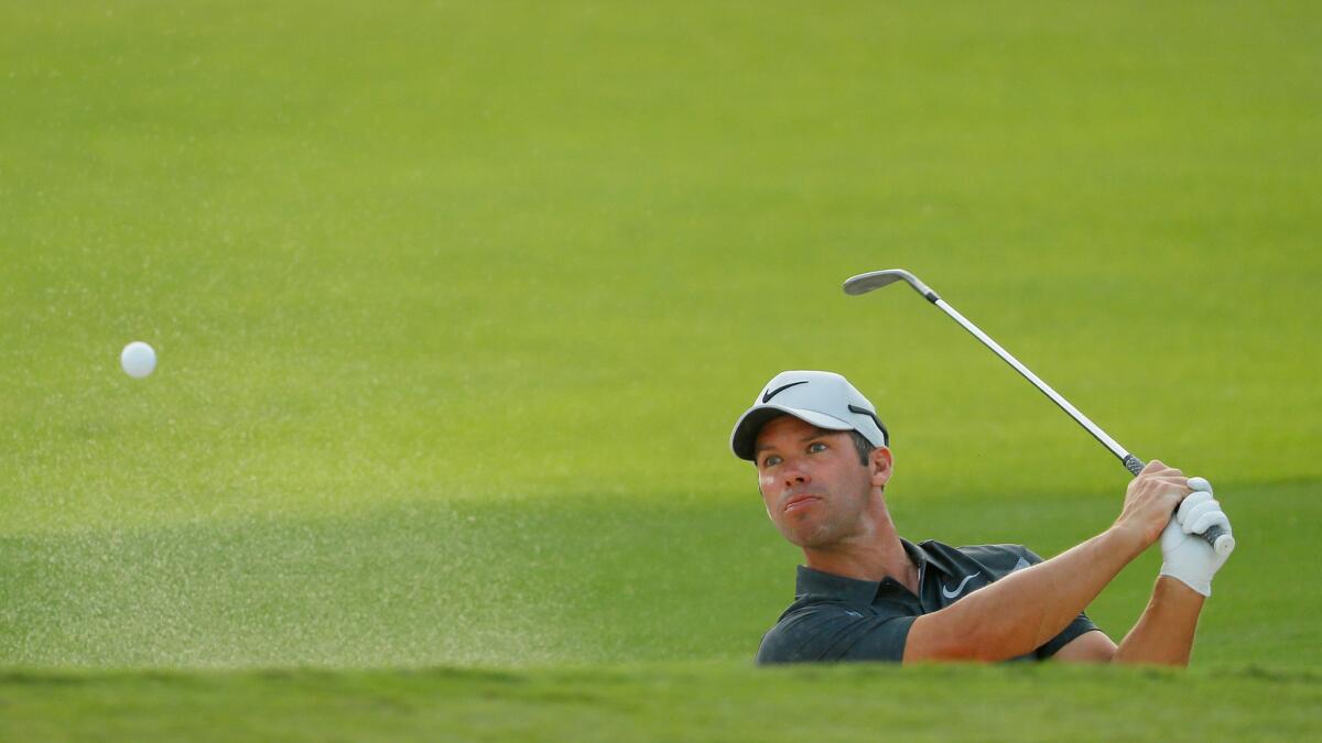 Paul Casey of England plays a shot from a bunker on the 18th hole during the third round of the Tour Championship on Saturday.