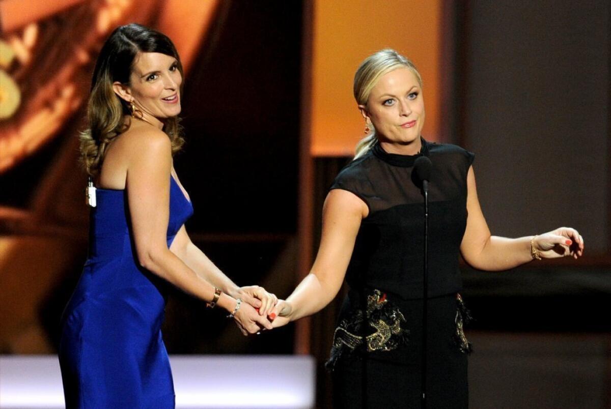 Tina Fey, left, and Amy Poehler will be returning to host the Golden Globes.