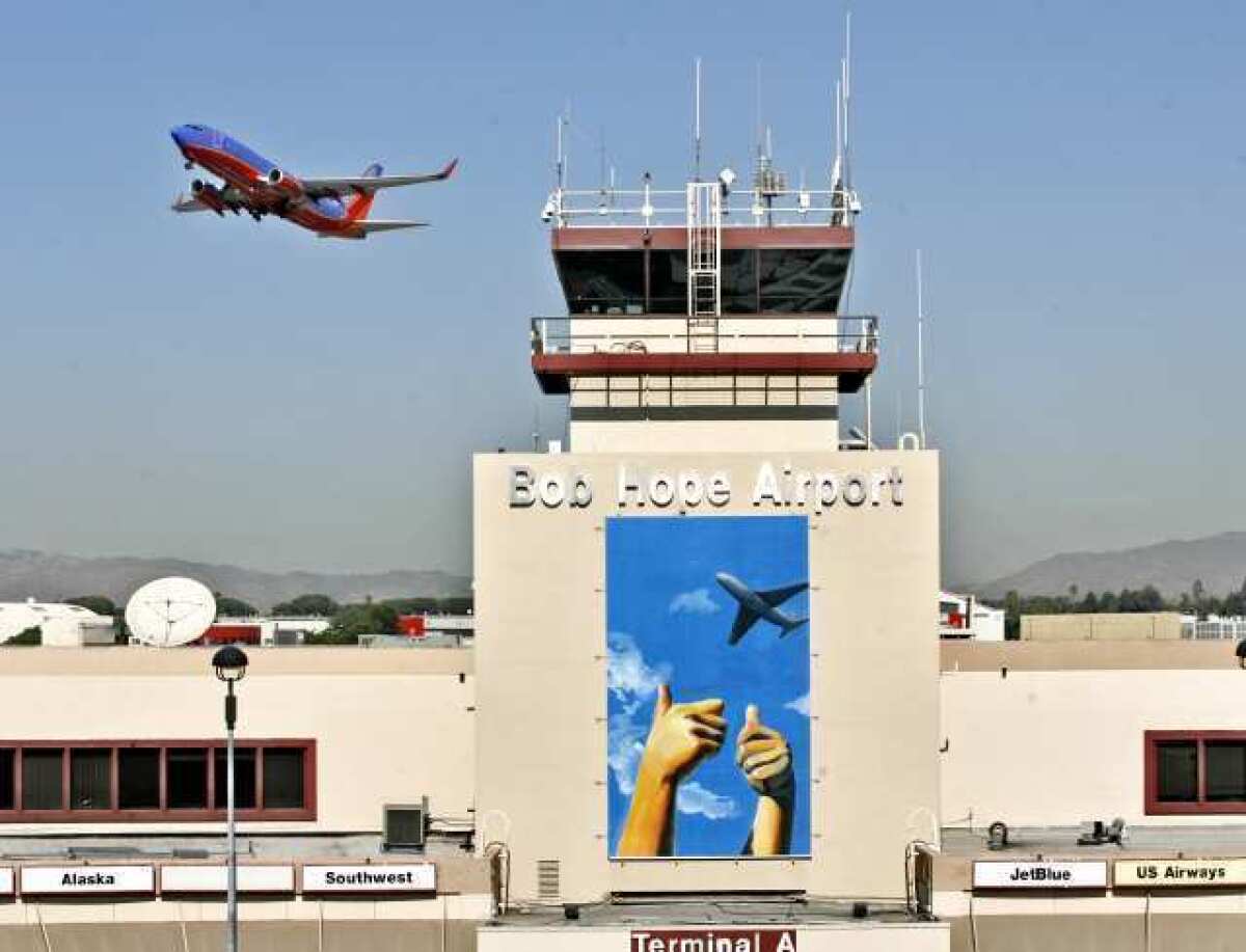 An airplane takes off at the Bob Hope Airport, where new art created by a student is being displayed at the airport's main entryway. The artwork was created by former Crescenta Valley student Iris Kim.