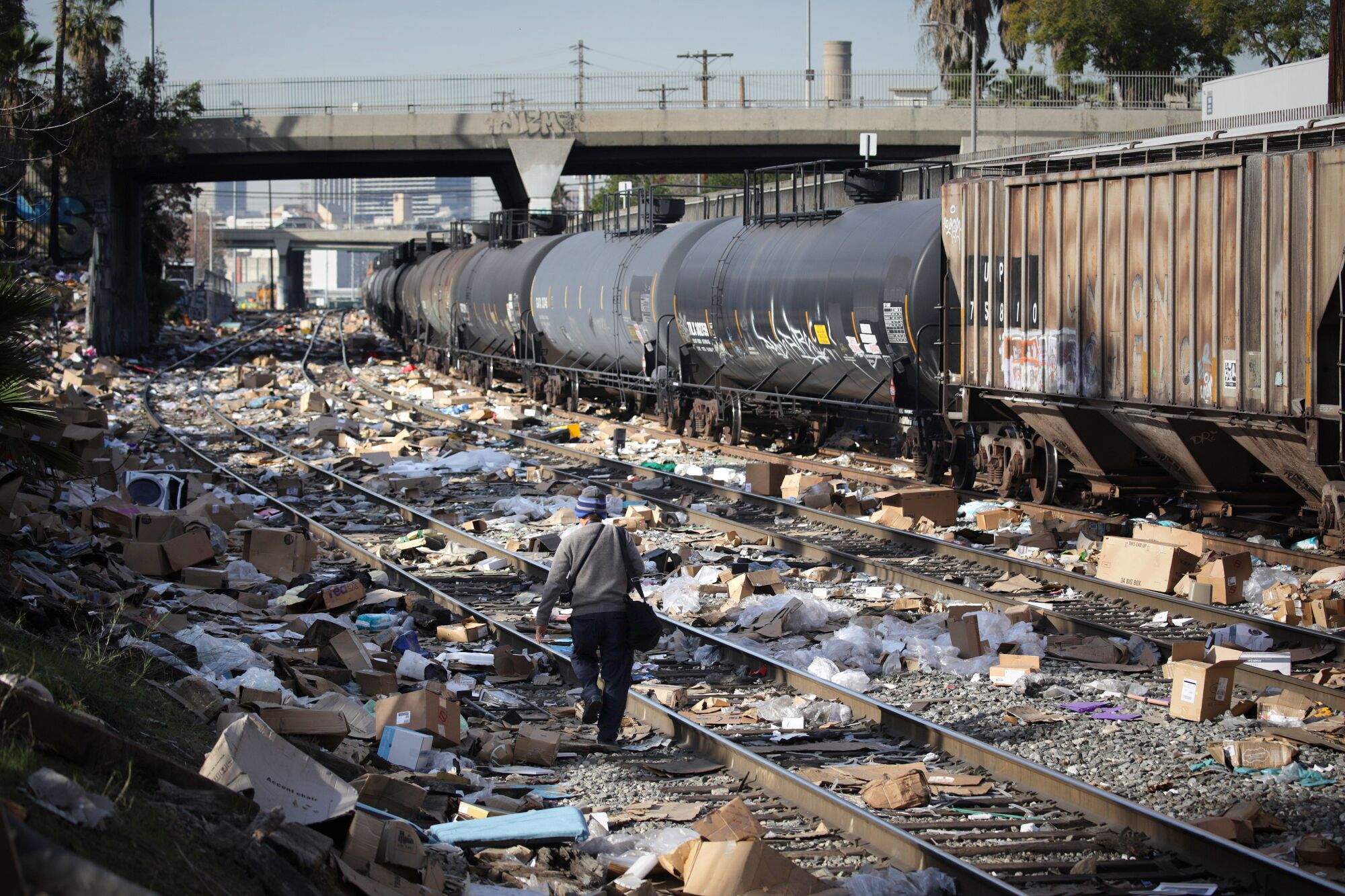 A man walks along a section of Union Pacific train tracks in downtown Los Angeles.