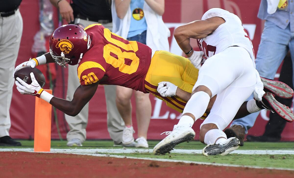 USC receiver Deontay Burnett dives into the end zone for a touchdown against Stanford during the second quarter of a game against Stanford at the Coliseum.