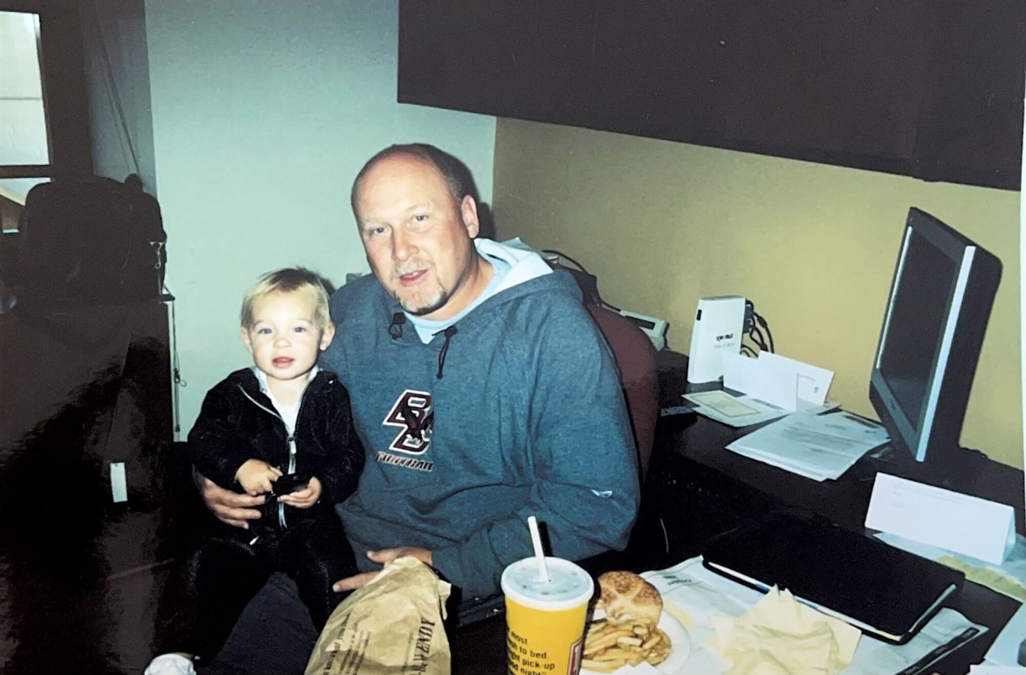 Bill McGovern during his days at Boston College with a very young Mackenzie McGovern on his lap.