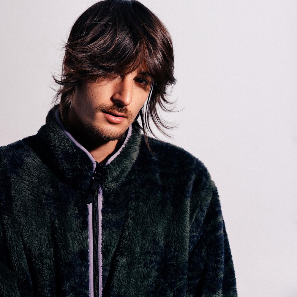 Portrait of Danny Ocean in a dark zip-up jacket