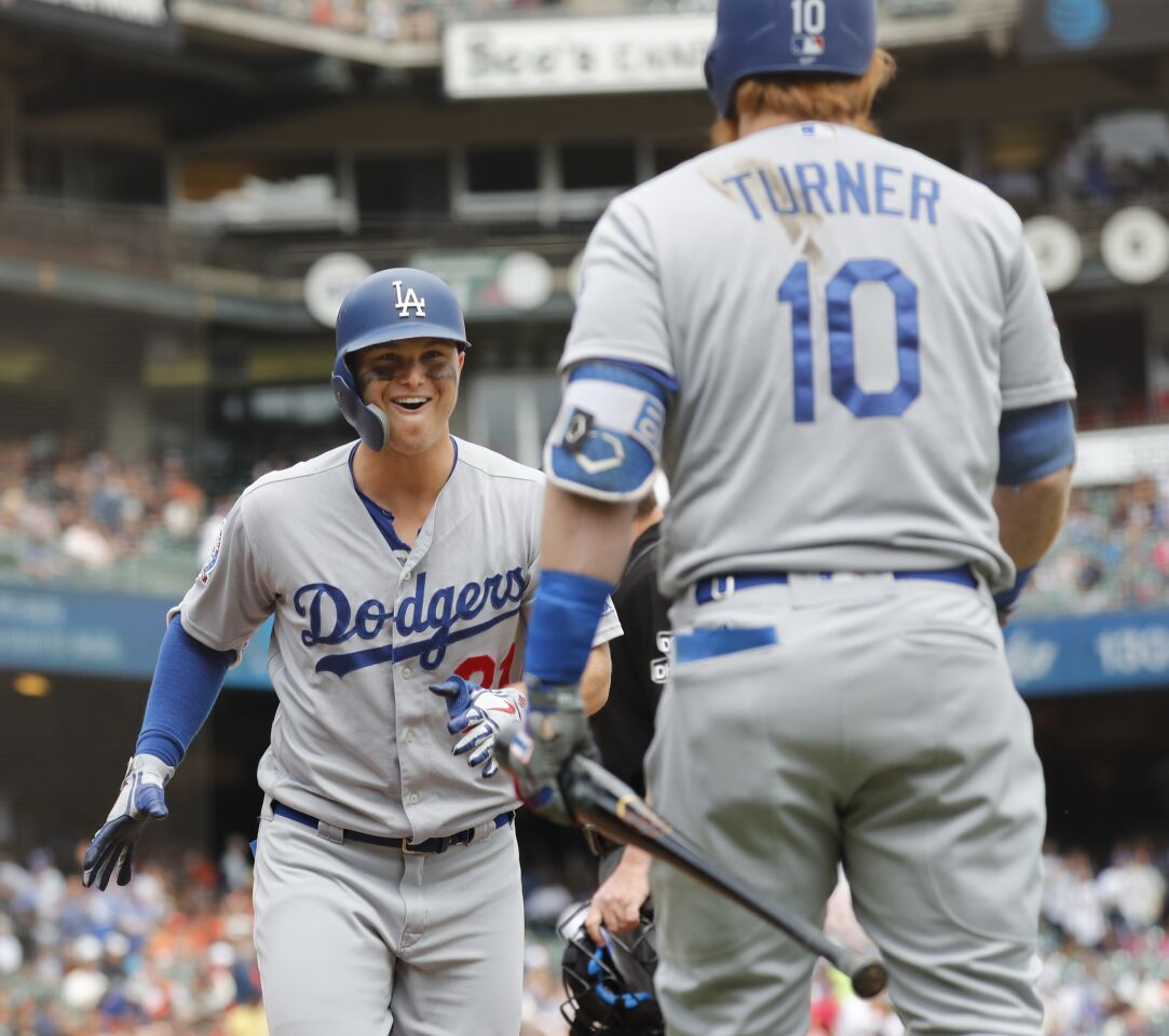 Los Angeles Dodgers' Joc Pederson (31) celebrates scoring a home run with Justin Turner (10) during the first inning of a baseball game in San Francisco, Saturday, Sept. 29, 2018. (AP Photo/Jim Gensheimer)