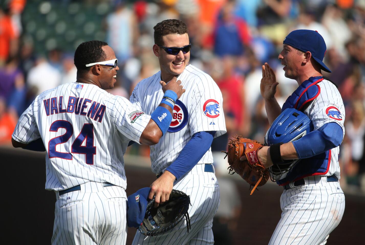 Luis Valbuena, Anthony Rizzo and John Baker celebrate the win.
