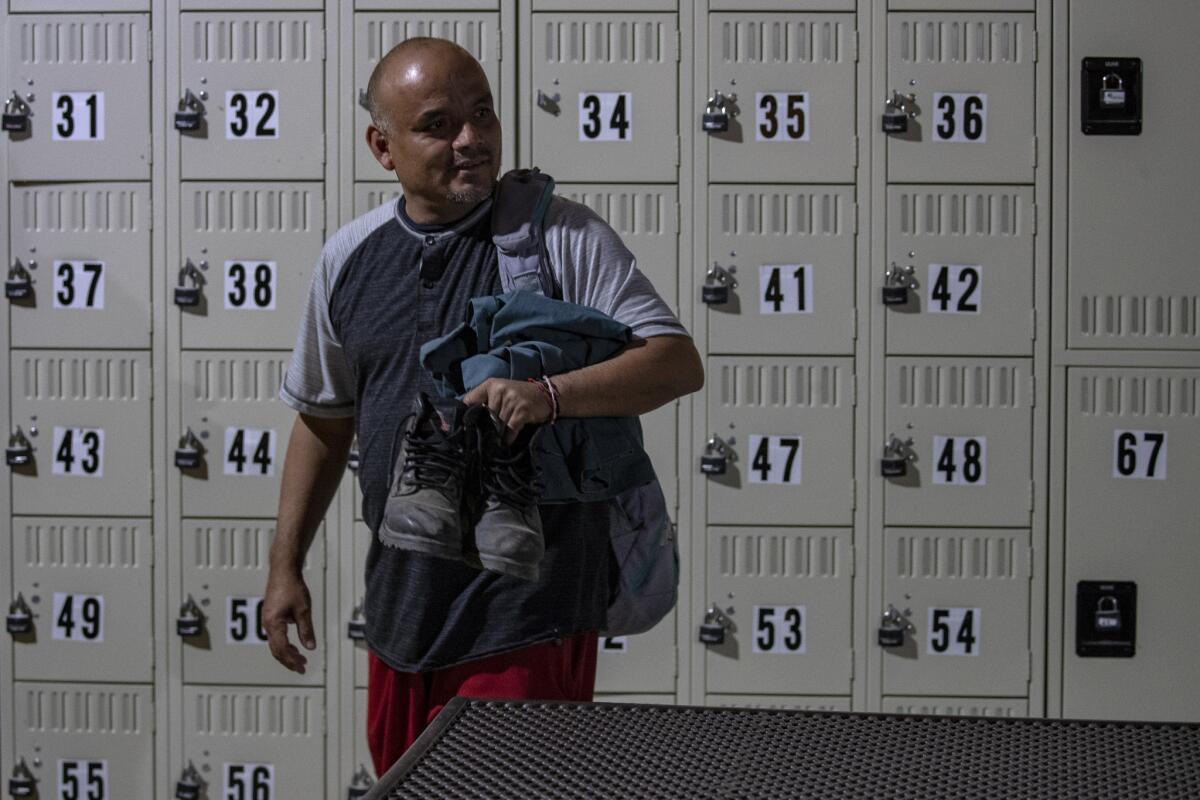 Martinez gets ready for morning at Our Lady of Guadalupe shelter in Mecca. (Irfan Khan / Los Angeles Times)