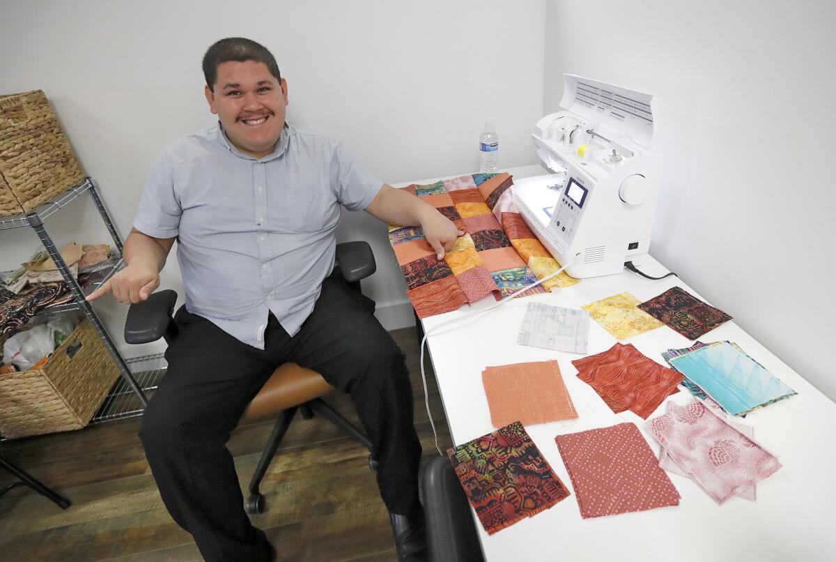 Founder Juan Garcia sits at his quilting work station at Zuggy Etc. workspace.