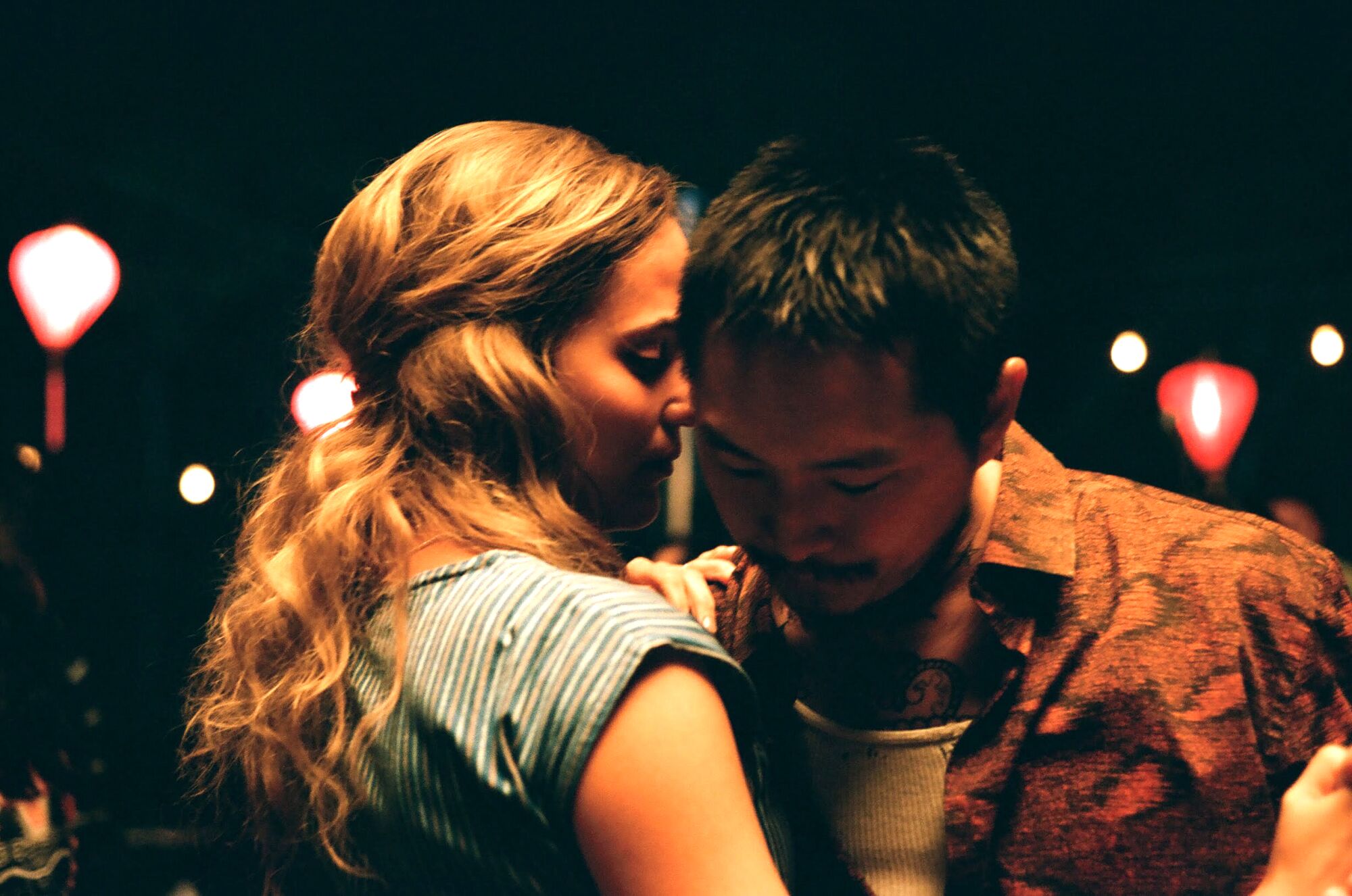 Alicia Vikander and Justin Chon dance up close in "Blue Bayou."