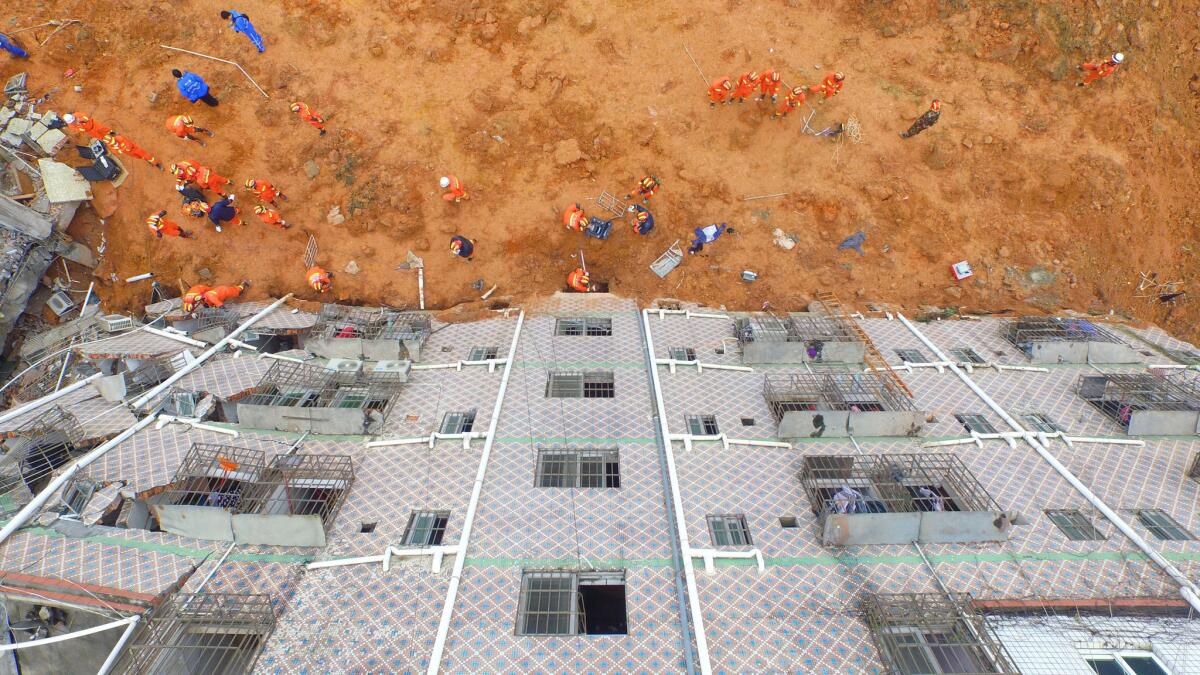 In this aerial photograph, Chinese rescuers can be seen working at the site of a landslide that hit an industrial park in Shenzhen in south China's Guangdong province.