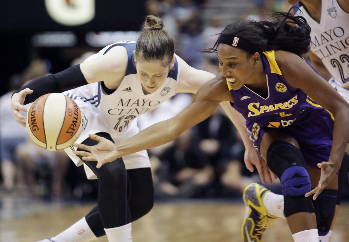 Candice Wiggins and Lindsay Whalen of the Lynx battle for control of the ball during the second half of a game on July 8.
