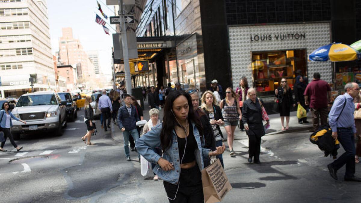 Consumer spending, which accounts for about two-thirds of U.S. economic output, was the biggest driver of growth in the second quarter. Above, shoppers walk along Lexington Avenue in New York City in April.