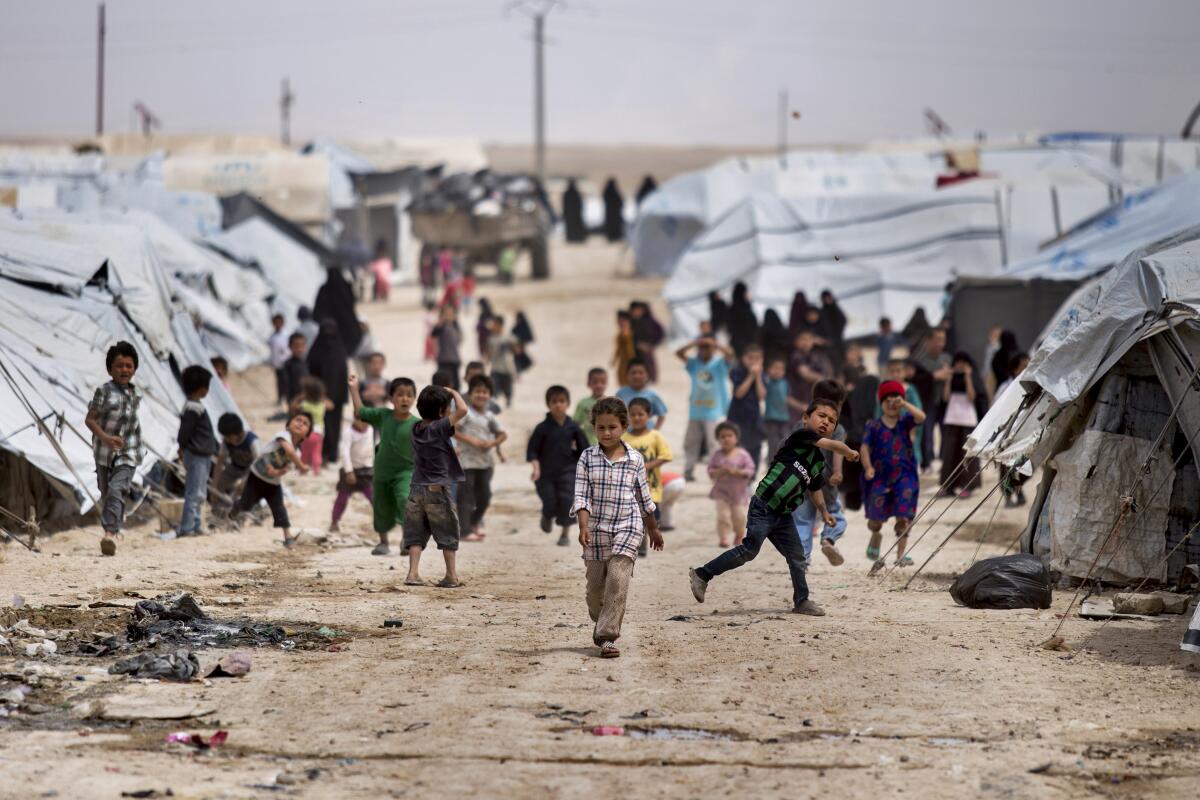 FILE - Children gather outside their tents at the al-Hol camp, which houses families of members of the Islamic State group, in Hasakeh province, Syria, May 1, 2021. Doctors Without Border warned in a report released Monday, Nov. 7, 2022, that the camp is witnessing pervasive violence, exploitation and lawless at a time when countries that have citizens in the facility have failed to take responsibility for protecting them. (AP Photo/Baderkhan Ahmad, File)