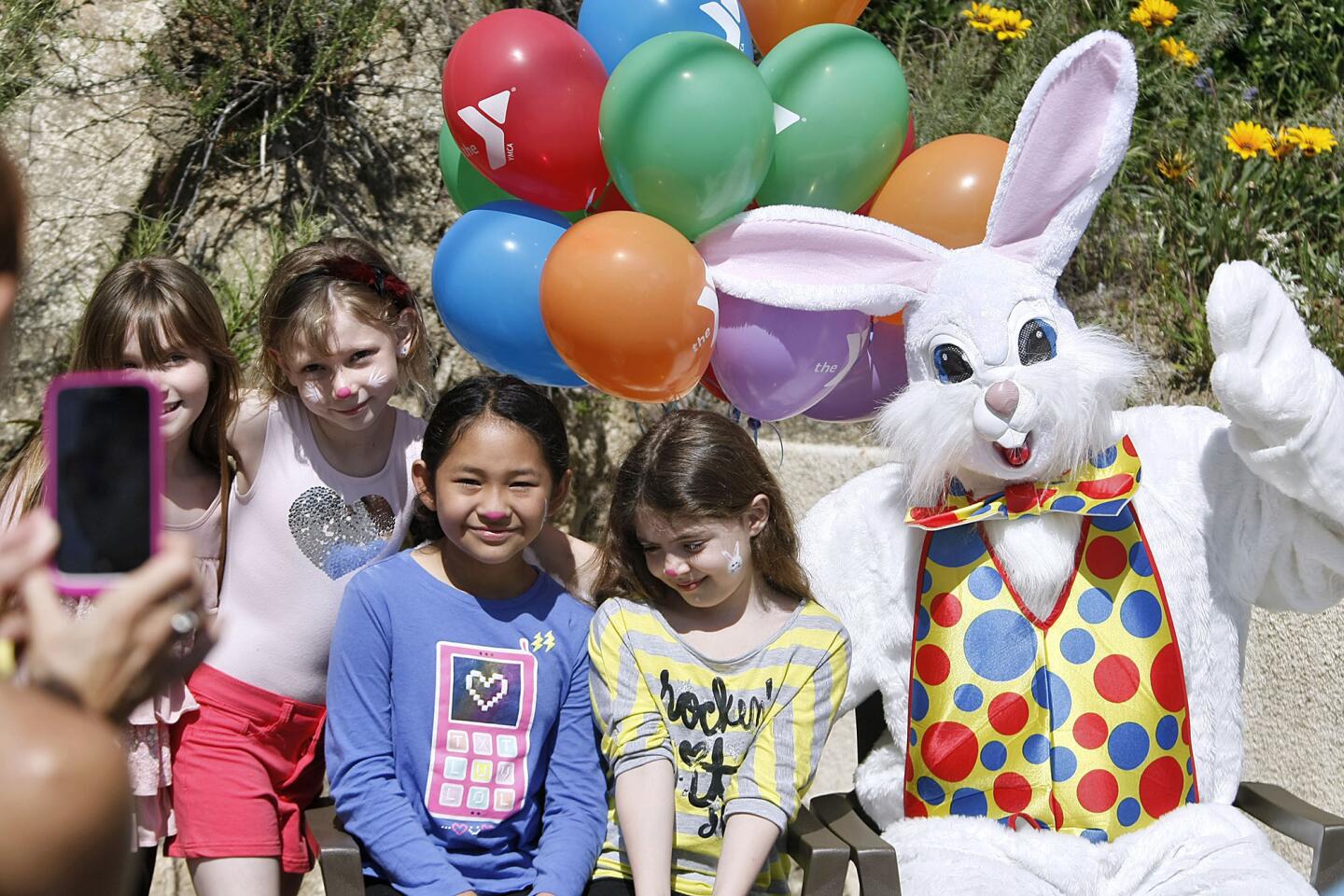 From left, posing for a photo with the Easter Bunny are Scarlett Conroy, Yasmine Anderton (cq), Emily Garcera and Mia Maalouf, all from Glendale, at the Crescenta-Canada Family YMCA 2nd Annual Easter Egg Hunt and Carnival in La Canada Flintridge on Friday, March 29, 2013.