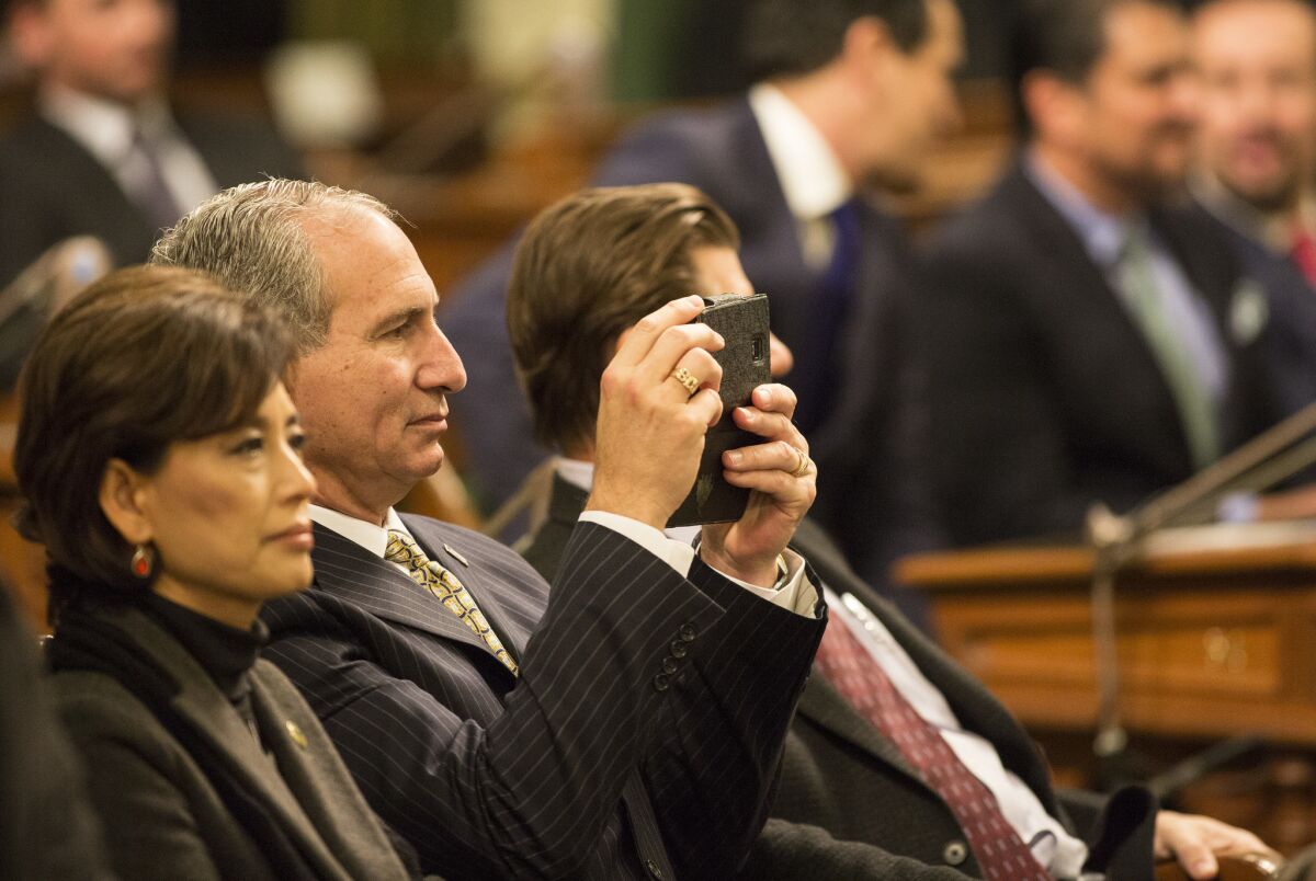 State Sen. Jeff Stone takes photographs during Gov. Jerry Brown's 2016 State of the State address. (Brian van der Brug / Los Angeles Times)