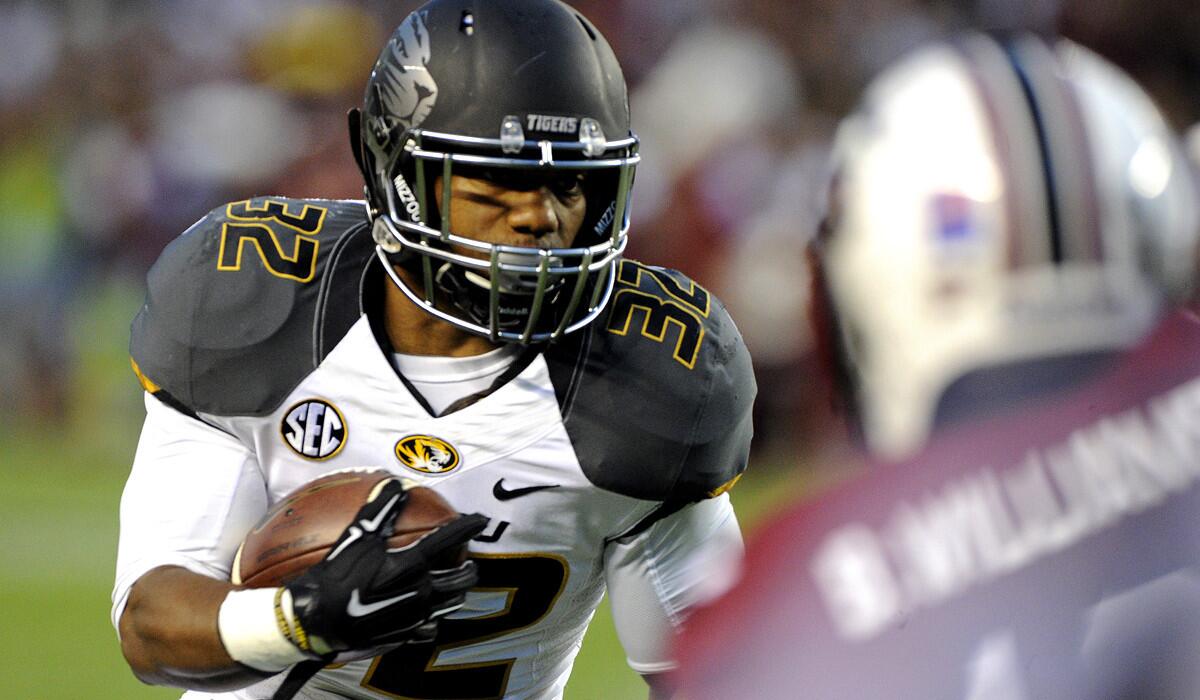 Missouri tailback Russell Hansbrough heads toward the end zone in the first quarter for the first of his three touchdown runs against South Carolina on Saturday.