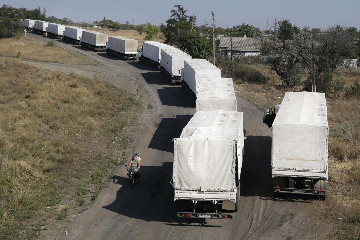 Trucks from a controversial Russian aid convoy to Ukraine stand in line as they wait to return to Russia at a border post near Izvaryne in eastern Ukraine on Aug. 23.