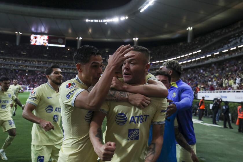America's Jonathan Rodriguez, center, is congratulated after scoring his side's opening goal against Chivas during a Mexican soccer league match at Akron stadium in Guadalajara, Mexico, Saturday, March 18, 2023. (AP Photo)